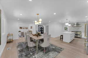 Dining room featuring an inviting chandelier and light hardwood / wood-style floors