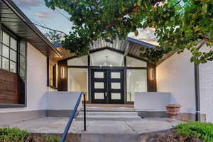 Exterior entry at dusk featuring french doors