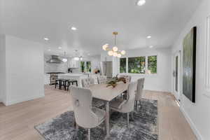 Dining area featuring an inviting chandelier and light hardwood / wood-style floors