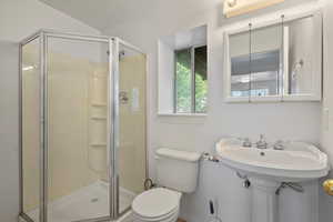 Bathroom featuring walk in shower and toilet