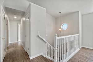 Hallway featuring hardwood / wood-style flooring and a textured ceiling