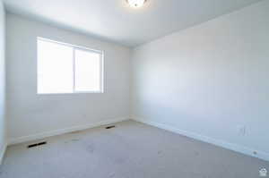 Unfurnished room featuring carpet flooring