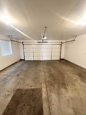 Large two car garage with more parking available behind and along the side