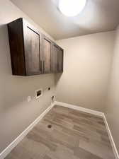 Large laundry room with upper cabinet storage