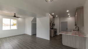 Kitchen featuring ceiling fan, sink, stainless steel appliances, and dark hardwood / wood-style floors