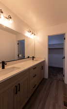 Bathroom with hardwood / wood-style floors and vanity