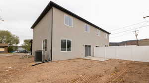Rear view of house featuring a patio and central AC unit