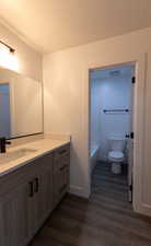 Bathroom featuring hardwood / wood-style floors, vanity, a textured ceiling, and toilet
