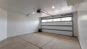 Garage featuring a garage door opener