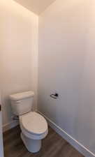 Bathroom with hardwood / wood-style floors and toilet