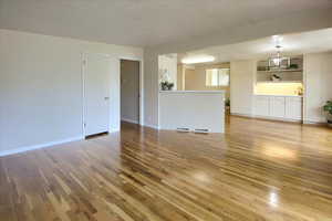 Unfurnished living room featuring light hardwood / wood-style flooring