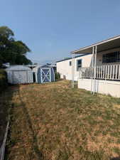 View of yard with a storage unit