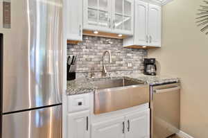 Stainless Refrigerator, Farm Sink, and Dishwasher.