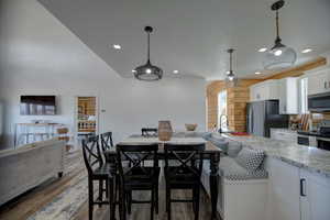 Dining area with wood finished floors, recessed lighting, and wooden walls