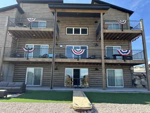 Rear view of property with a balcony, a patio area, and an outdoor hangout area