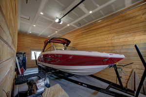 Garage featuring wood walls and a garage door opener
