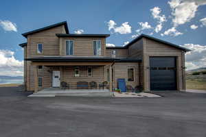 View of front of house featuring a porch, driveway, and a mountain view