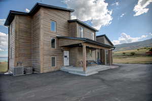 Back of house featuring covered porch and a mountain view