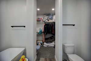 Bathroom with wood finished floors and toilet