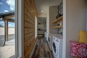 Laundry room featuring wood finished floors and separate washer and dryer