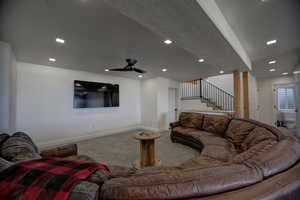 Living room with carpet floors, stairs, recessed lighting, and ceiling fan