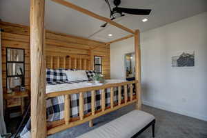 Carpeted bedroom featuring recessed lighting and ensuite bath