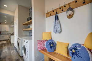 Laundry area with dark wood-style floors, washing machine and dryer, and recessed lighting