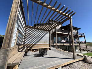 Wooden terrace featuring an outdoor fire pit