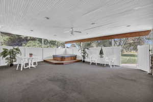 Unfurnished sunroom featuring ceiling fan