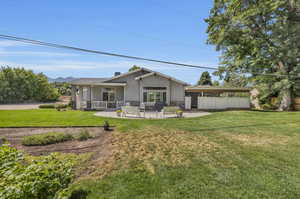 Rear view of property featuring a yard