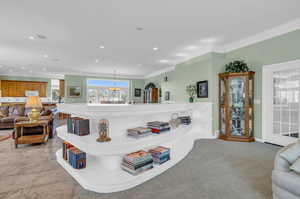 Dining area with light tile patterned flooring and ornamental molding