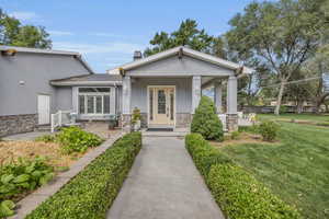 View of front of house with a front lawn and covered porch