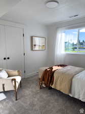 Bedroom with a textured ceiling and carpet flooring