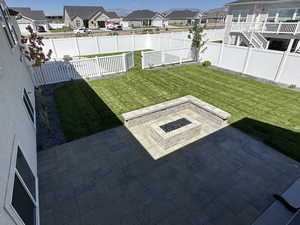 View of yard with a fire pit and a patio area