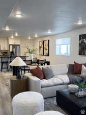 Living room featuring a textured ceiling and light hardwood / wood-style floors