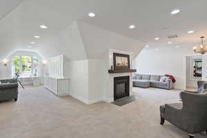 Bedroom featuring lofted ceiling and a chandelier