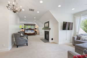 Bedroom featuring vaulted ceiling, a wealth of natural light, and a chandelier