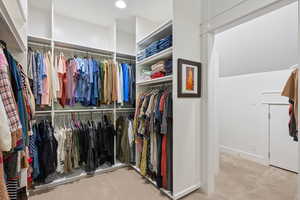 Walk in closet featuring light carpet