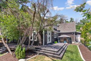 Back of property with french doors and a deck