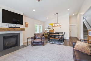 Guest house living room featuring dark wood-type flooring and vaulted ceiling