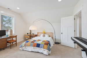 Carpeted bedroom with vaulted ceiling