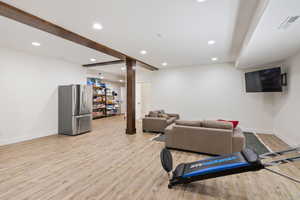 Living room featuring decorative columns and light hardwood / wood-style flooring