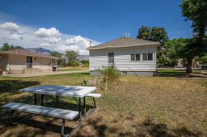 Rear view of property featuring a yard