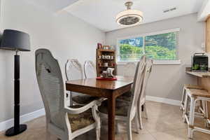 Dining room with light tile patterned floors