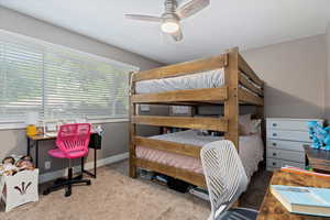 Carpeted bedroom with ceiling fan