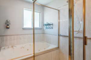 Bathroom featuring shower with separate bathtub