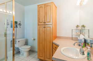 Bathroom with vanity, toilet, and tile patterned flooring