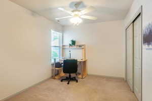 Carpeted office space with ceiling fan