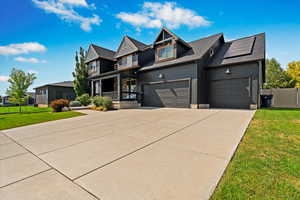 View of front facade featuring a front yard and a garage