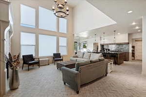 Living room with a high ceiling and an inviting chandelier